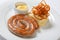 Mashed potato and roasted sausage or bratwurst on white plate