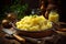 Mashed potatoes with butter, fresh herbs and milk in ceramic bowl on a wooden table, rustic background. Homemade creamy mashed