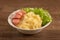 Mashed potatoes with green lettuce and small sausage