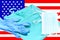 Mask, gown and gloves of an emergency physician to fight the viruson the flag of the united states