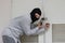 Masked burglar wearing a balaclava escaping after sneaking into the house. Crime concept