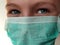 Masked child. The face of a 7-year-old boy in a protective surgical mask close-up. Schoolboy with blond hair and blue-gray eyes