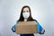 Masked delivery woman delivers food during virus outbreak, coronavirus panic and pandemics
