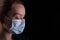 Masked girl, protection against coronavirus 2020, Chinese virus, epidemic, mass panic, pneumonia, flu, buying masks. On a black