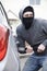 Masked Man Breaking Into Car With Crowbar