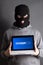 Masked man with loading computer over grey