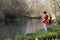 A masked man on a river fishing during quarantine, a violation of self-isolation during the coronavirus pandemic