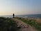 A masked man stands alone near the Mediterranean Sea in winter in Israel.