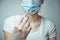 A masked nurse holds a syringe with a vaccine against the virus COVID-19