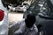 Masked robber in a balaclava ready for stealing automobile car. Robbery and crime concept