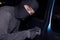 Masked thief with balaclava with key to breaking into a car. Crime concept