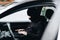 Masked thief hacker in a balaclava disarming car security systems