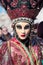 Masked woman with flashy hat at the Carnival of Venice