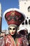Masked woman with flashy hat at the Carnival of Venice