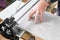 The mason cuts a ceramic tile with a tile cutter