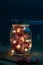 Mason Jar with fairy lights and dried red maple leaves