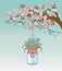 Mason jar with flower hanging in tree branch