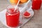 Mason jar of fresh citrus juice on table