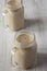 Mason jar mugs filled with banana, kiwi, apple smoothie, low angle view