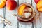 Mason jar of peach iced tea on wood, downward view