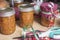 Mason jars filled with homemade orange marmalade being decorated