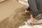 Mason leveling the cement screed