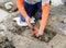 Mason repairing the drain of a patio