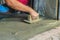 Mason worker use trowel to smooth or leveling liquid concrete of