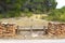 Masonry stone wall wooden fence pine forest