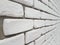 Masonry walls of white silicate brick bonded with cement in the future in perspective. Artistic texture and background. Outdoor