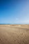 Maspalomas coastal sand dunes in Gran Canaria, Spain. Desert-like sand area, blue sky and sunshine. No people in sight, just