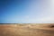 Maspalomas coastal sand dunes in Gran Canaria, Spain. Desert-like sand area, blue sky and sunshine. People and tourists enjoying