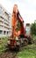 Mass cutting of adult poplars in the city. The excavator with bucket moves the wooden pieces