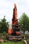 Mass cutting of adult poplars in the city. The excavator with bucket moves the wooden pieces