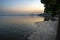 Mass death of fish floating on polluted lake water. Photo taken at sunrise