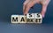 Mass market symbol. Businessman flips wooden cubes with words `mass market`. Beautiful grey background, copy space. Business and