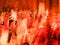 Mass of red color in motion blur abstract of unrecognizable people dancing