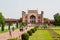 Mass tourism in India and a lot of tourists walking around the Taj Mahal monument and the entrance Great Gate