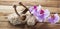 Massage accessory and orchid flowers on wood background with orchids for relaxation