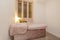 Massage cabin with pink velvet upholstered table