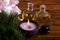 Massage oils, orchid flower, pebbles on bamboo