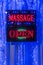 A `Massage Open` sign hanging in a window