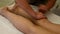 Massage procedure of female back in spa salon. Closeup hands of masseur.