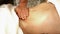 Massage procedure of female back in spa salon. Closeup hands of masseur.