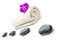 Massage stones and violet orchid flower on a towel