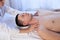 A massage therapist makes man medical back massage and body treatments at the Spa