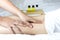 Massage therapist\\\'s hand massages young woman\\\'s calf muscles in spa salon.
