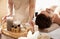 Massage therapist with spa essentials and young man