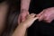 Massagist scrubbing woman hand and fingers natural scrub in spa salon, closeup.