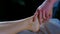 Massagist scrubbing woman`s foot with natural scrub in spa salon peeling body.